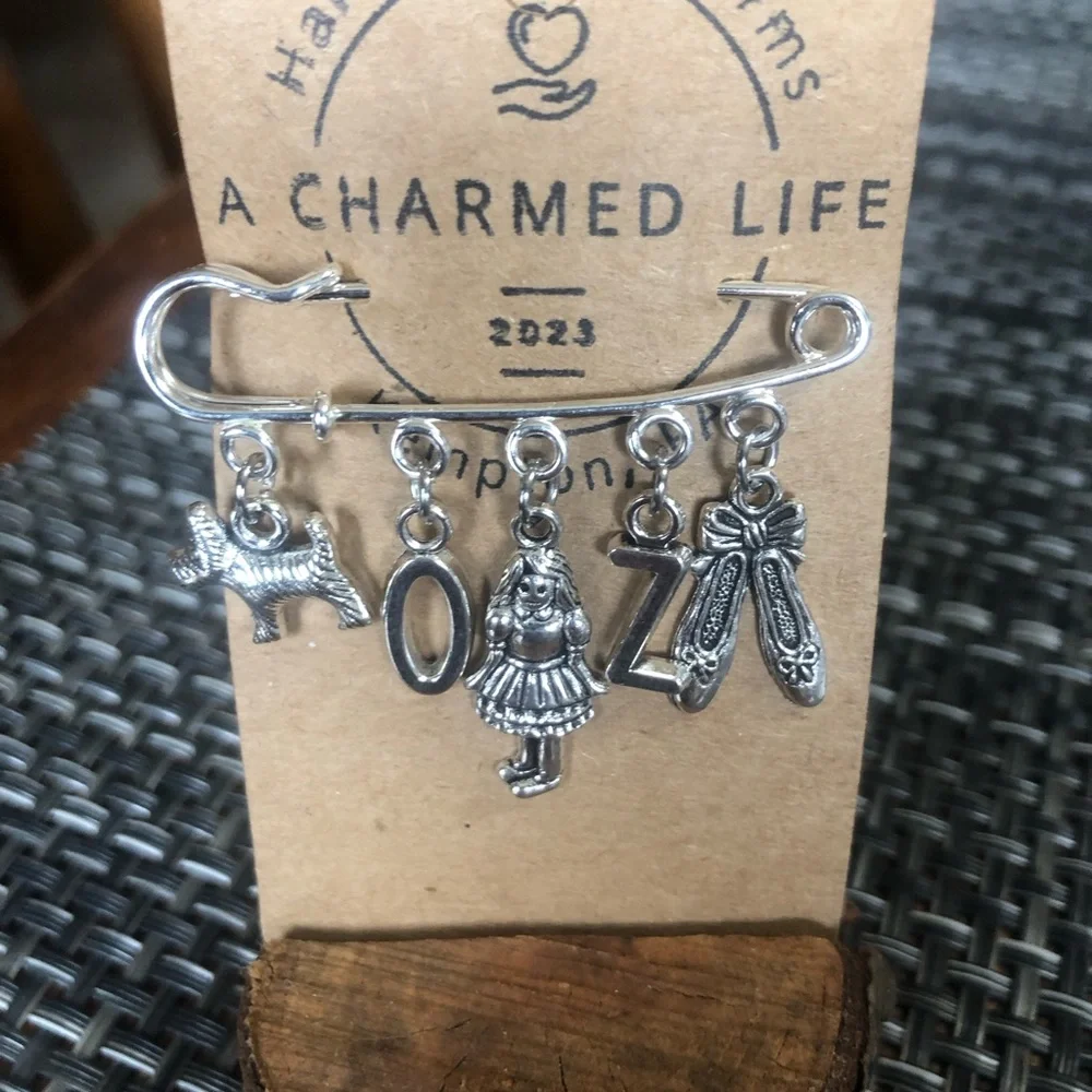 NWT, Handmade by A Charmed Life. Wizard of Oz Silver Charms/Silver 2” Pin